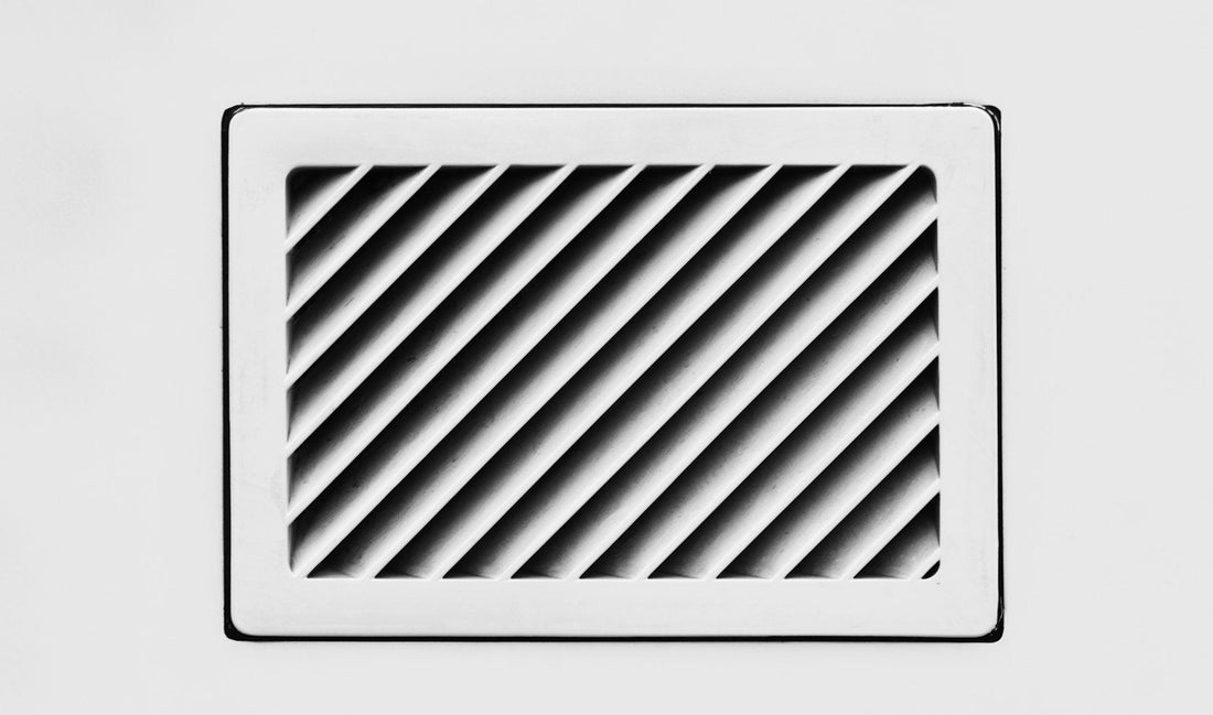 Close-up of a bathroom ventilation grille ready for cleaning
