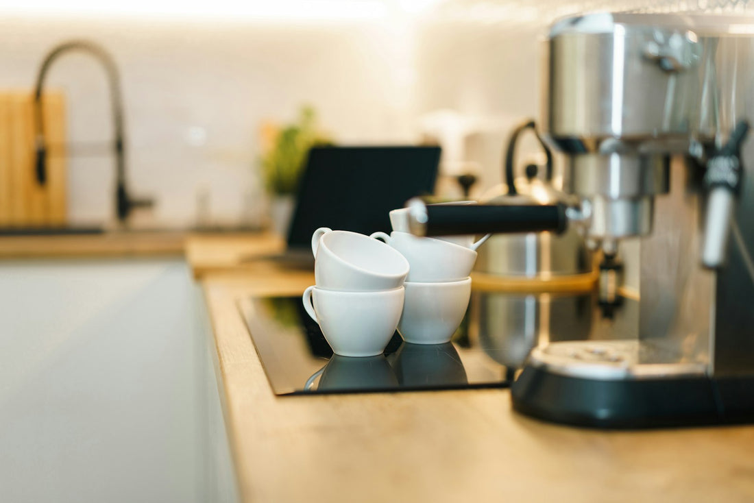 Drip coffee maker and cups arranged on a modern kitchen counter