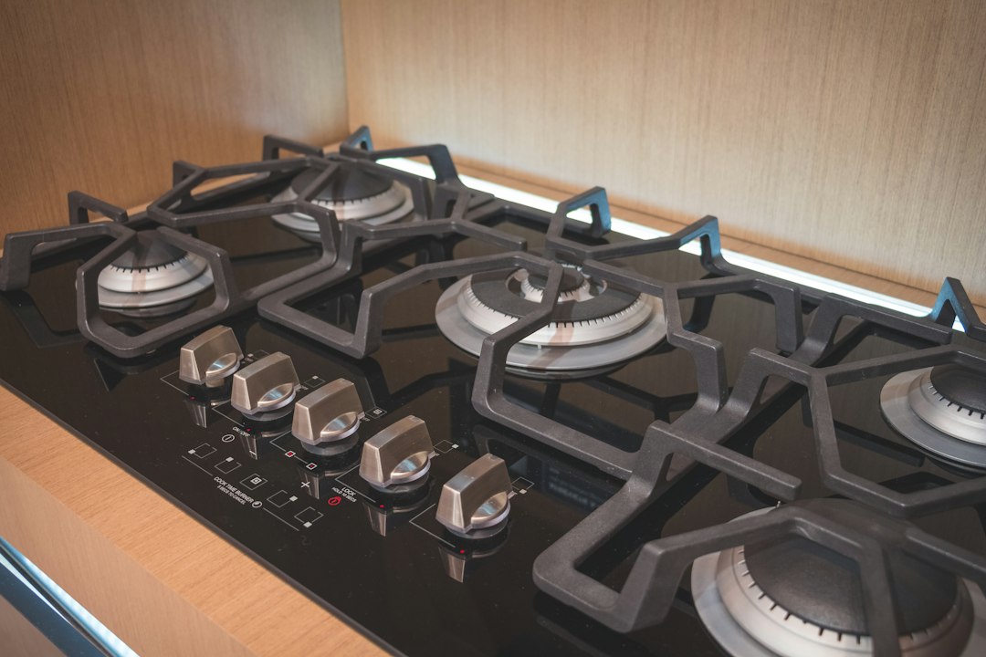 Black and silver gas stovetop with removable burner grates
