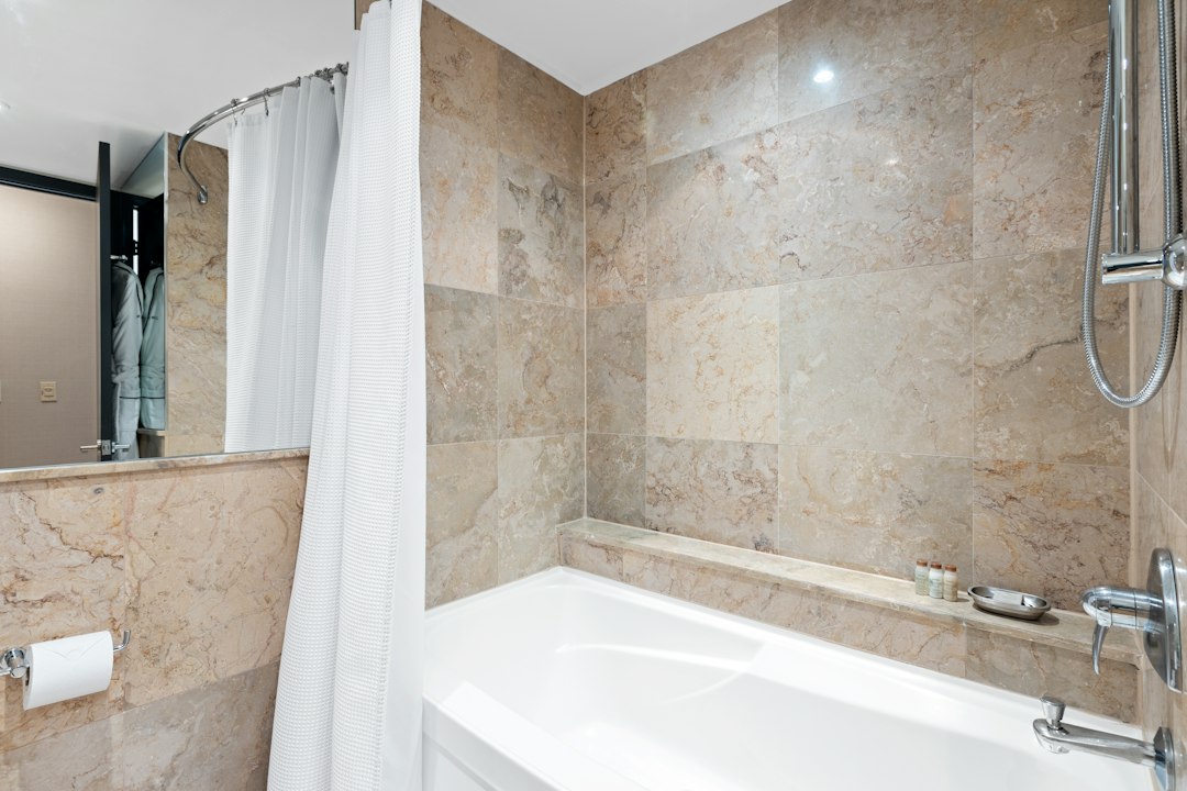 White bathtub with a white shower curtain in a bathroom