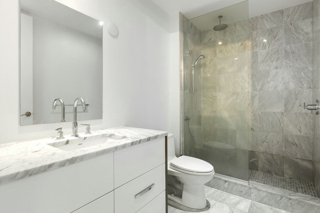 Modern bathroom with a clear glass shower door and metal frame