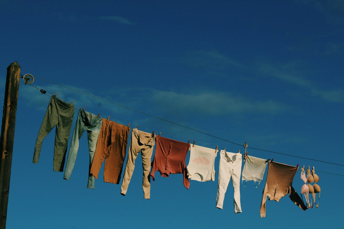 White and blue laundry drying on a clothesline in daylight