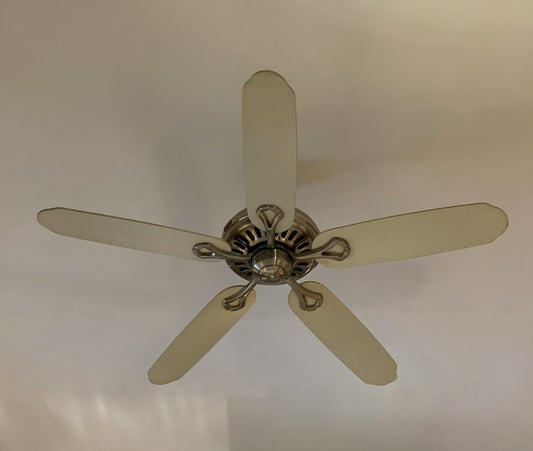 A white five-blade ceiling fan viewed from below