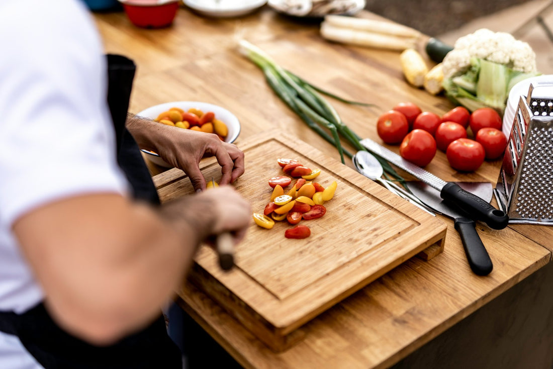 A person preparing fresh vegetables on a cutting board