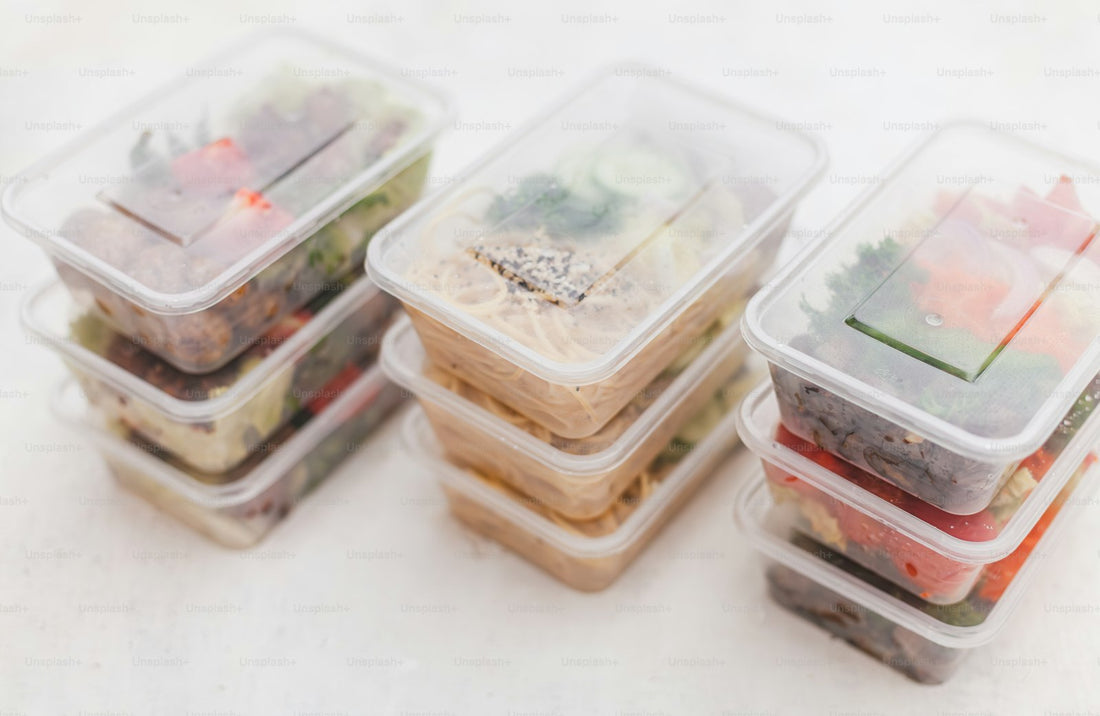 A group of organized food storage containers filled with prepared food